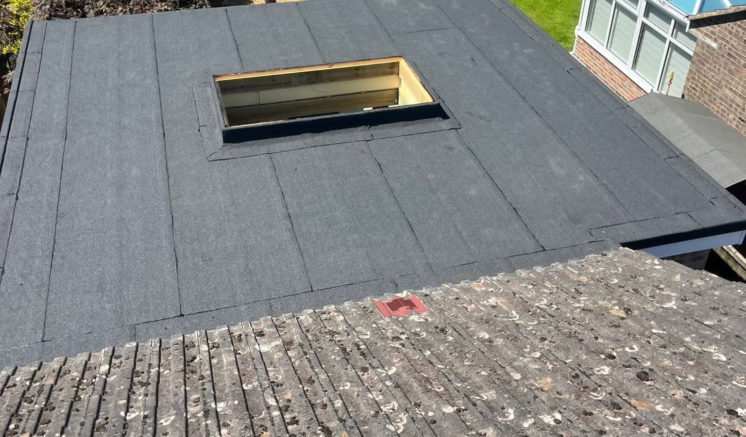 Flat extension roof finished in mineral felt with an upstand ready for a rooflight, seen from above