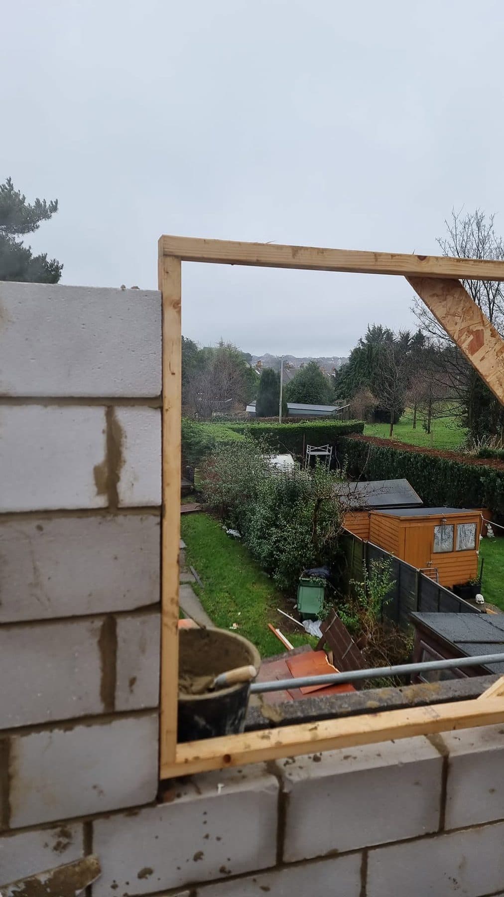 View from first-floor level through a timber window former set in new blockwork